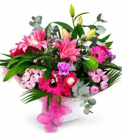 Pink Extravagance - A vibrant floral arrangement in rich pink and fresh green tones, beautifully presented in a keepsake container to make a memorable gift for birthdays, congratulations or any special occasion.